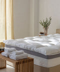 Matratzen Bundle mit federfreiem Topper auf einer hochwertigen Matratze, präsentiert in einem modernen Schlafzimmer mit wohnlicher Atmosphäre.